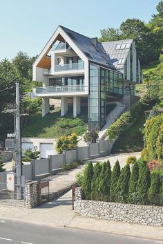 a house on the side of a hill with stairs leading up to it's second story