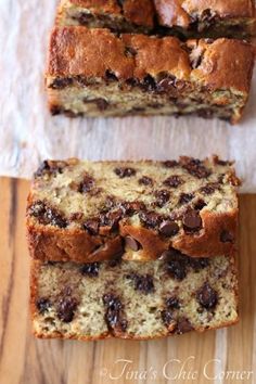 two slices of chocolate chip banana bread on top of a wooden table next to each other