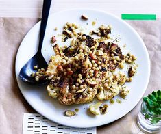 a white plate topped with food on top of a table