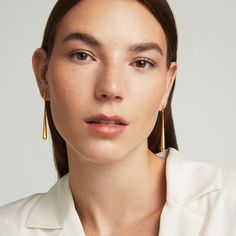 Made for the minimalist, these understated earrings feature elongated teardrops in a clean brushed finish. The pendulum-style structure hypnotizes with its subtle sway.  Material: DD Signature Brushed 22-Karat Gold or Palladium Finish Over High-Quality Brass. Learn more. 

Lightweight
Designed in Toronto

Length: 59mm / 2.3 inchWeight: 4.5g / 0.16oz Felt Pouch, Artfully Designed, Black Friday Promotions, Mission Statement, Keepsake Jewelry, The Minimalist, Crafted Jewelry, Style Earrings, Small Accessories