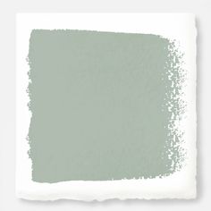 a white square with some gray paint on it's side and the color is light green