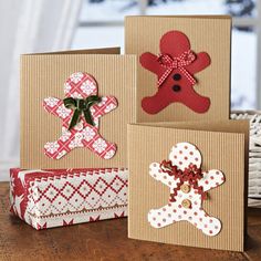 some cards are sitting on a table and one has a teddy bear, the other is a gingerbread man