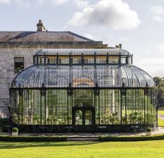 a large glass house with many plants in it