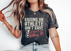 Reward your hard working sports parent with this hilarious tee shirt! Whether it's for a mom who drives to every practice, or a dad who never misses a game, the parent of an athlete deserves to be cheered on, too! Our Tee Shirts are unisex sizes, so anyone can wear them! -------------------- Click here for more T-Shirt Options: https://www.etsy.com/shop/WildshapeWardrobe Click Here to Return to WildshapeWardrobe: https://wildshapewardrobe.etsy.com -------------------- DTG printing utilizes water-based ink that permeates the fabric instead of staying on the surface, resulting in more breathable garments that feel softer and more flexible. Product Details:  * Graphic designed by Me!  * 100% cotton (Heather colors contain polyester)  * Fabric weight: 5.0-5.3 oz/yd² (170-180 g/m²)   * Open-end Athletic Heather Tops For Sports Fans, Athleisure Athletic Heather T-shirt With Letter Print, Sports Fan Apparel Tops With Slogan, Slogan Sports Tops For Sports Season, Relaxed Fit Slogan T-shirt For Sports Events, Athletic Heather Tops For Sports Events, Athletic Heather Athleisure Tops For Sports Events, Team Spirit Crew Neck T-shirt For Workout, Athletic Heather Graphic Tee For Sports Season