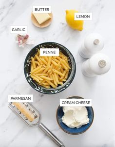 ingredients to make penne with butter, cream and lemon on a white marble counter top