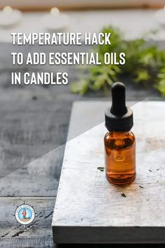 a bottle of essential oil sitting on top of a cutting board with herbs in the background