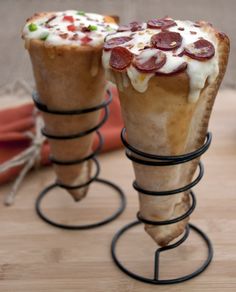 there are two cones with different toppings on top of each other, one has pepperoni and the other has cheese