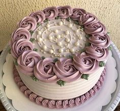 there is a large cake with purple icing on it