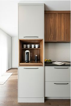 a kitchen with wooden cabinets and white appliances in the center, is shown on an appliance