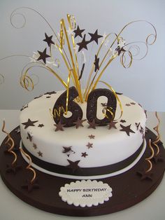 a birthday cake with the number sixty on it and gold stars in the top tier