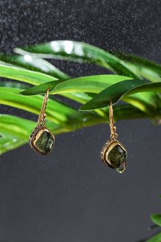 DETAILS: ♥ All of our products are handmade. ♥ All you orders are shipped in a minimalist gift box and cleaning cloth. ♥ We use high quality 925K Sterling Silver and 14K Gold in all of our products. ♥ If you order 1 piece, it will be sent as a pair.♥ ♥This Moldavite Crystal Earrings will accompany your sparkle and will be a very special gift on special occasions such a mother's day, birthday, graduations, wedding organizations, Christmas.♥ ♥TAKE A GOOD CARE♥ Please follow these tips to keep it l Wire Wrapped Fusion Earrings For Gift, Fusion Style Wire Wrapped Earrings For Gift, Handmade Brass Crystal Earrings As Gift, Handmade Brass Crystal Earrings For Gift, Handmade Fusion Earrings Gift, Handmade Fusion Earrings As Gift, Fusion Style Dangle Earrings For Gift, Fusion Gemstone Earrings For Gifts, Fusion Style Gemstone Earrings For Gift