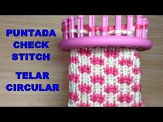 a pink and white knitted object with the words puntta check stitch on it