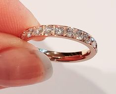 This is a gorgeous rose gold cubic zirconia band. 3 mm wide and super shiny. This band is 14 kt rose gold over stainless steel. Shines with a brillant fire. This ring is completely hypoallergenic, wear all day everyday. Swim, shower, very comfortable. Perfect to wear alone or as a spacer ring with any of my name rings. I guarantee customer satisfaction, and feel free to ask any questions. Rose Gold Stackable Rings With Prong Setting, Stackable Rose Gold Cubic Zirconia Diamond Ring, Rose Gold Stackable Brilliant Cut Rings, Rose Gold Stackable Rings With Diamond Accents, Round Cut, Rose Gold Cubic Zirconia Stackable Diamond Ring, Rose Gold Cubic Zirconia Stackable Rings, Fine Jewelry, Rose Gold Diamond Ring With Vs Clarity, Stackable Rose Gold Eternity Band For Promise, Rose Gold Stackable Eternity Band For Promise Ring