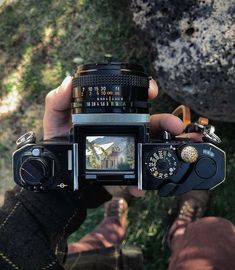 a person holding up a camera in their hand