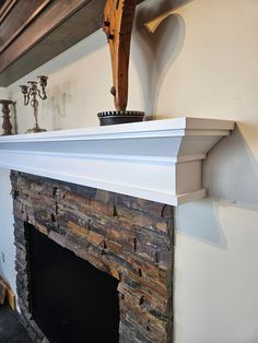 a fireplace with a wooden statue on top of it