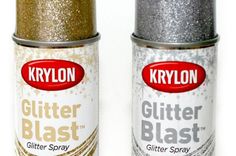 two spray cans with glitter on them sitting next to each other