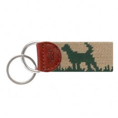 a keychain with a dog on it and a red leather tag hanging from the front