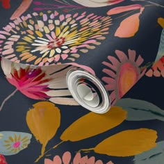 a wallpaper with colorful flowers on it and a roll of tape next to it