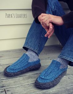 a person sitting on the ground wearing blue slippers