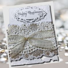 a close up of a happy anniversary card on a table with silver sequins