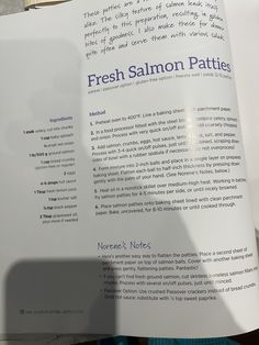 a person is holding up a menu for fresh salmon patties