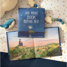 two children's books sitting on top of a bed next to some stuffed animals