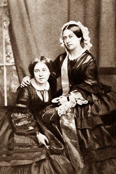 an old photo of two women sitting next to each other