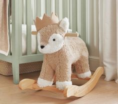 a stuffed animal that is on a wooden rocking horse