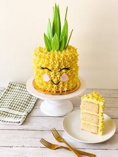 a pineapple cake decorated with yellow icing and a face drawn on the side