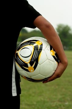 a man holding a soccer ball in his hand