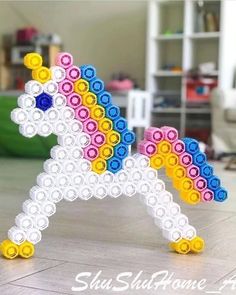 a colorful pony made out of plastic beads