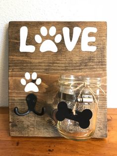 a wooden sign that says love with a dog's paw and mustache on it