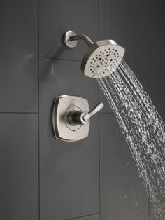 a shower head with water coming out of it's spout and spraying from the side