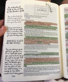 an open bible with writing on it and someone holding the book in their hand,