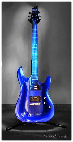 a blue electric guitar sitting on top of a table