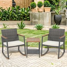 two chairs sitting on top of a brick patio