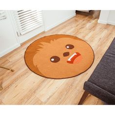 a floor mat with a face on it in the middle of a living room area