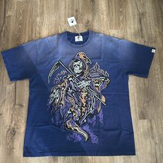 This Extremely Rare Warren Lotas Serenity Scythe Tee Is A Heavyweight T-Shirt That Every Collector And Streetwear Enthusiast Will Want To Own. Made From Premium, Durable Cotton, This Tee Offers A Robust Feel And Long-Lasting Comfort. The Standout Design Features A Striking Graphic Of The Reaper Holding A Scythe, With “Serenity” Emblazoned On The Blade, Beautifully Embodying Lotas’ Signature Blend Of Edgy Artistry And Unique Storytelling. With A Relaxed Fit, This Heavyweight T-Shirt Is Perfect Fo Purple Streetwear, Warren Lotas, Innovative Fashion, Blue And Purple, Tee Shirts, Mens Accessories, Mens Shirts, Man Shop, Relaxed Fit