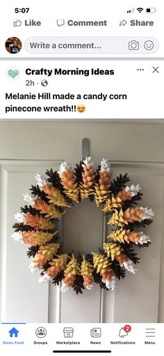 a wreath made out of fake pine cones on the front door with text that reads crafty morning ideas melanie hill made a candy corn