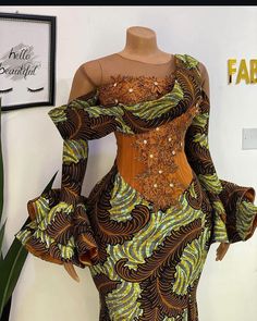 This has a very little but unique detailing that makes the dress ravishing. Green Ankara Fabric Party Dress, Green Ankara Party Dress, Ankara Fabric Floral Print Party Dress, Party Floral Print Ankara Fabric Dress, Party Floral Print Ankara Dress, Party Dress With Ankara Fabric And Floral Print, Party Dress With Floral Ankara Print, Spring Party Dress In Ankara Fabric, Elegant Multicolor Ankara Fabric Dress