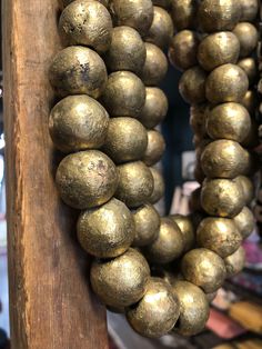 a close up of a bunch of metal balls on a wooden pole