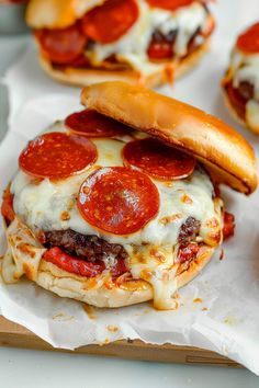 the cheeseburger has pepperoni on it and is ready to be eaten