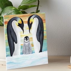 two penguins in the water with one penguin looking at another penguin art board print on canvas