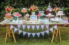 a table topped with lots of cakes and desserts