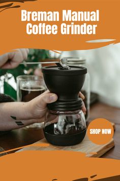 a coffee grinder is being held up by someone's hand with the words, breman manual coffee grinder shop now