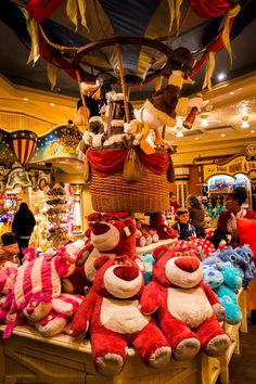 many stuffed animals are on display in a store