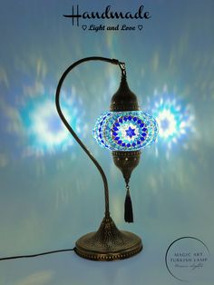 a lamp that is sitting on top of a table next to a blue background with the words, handmade light and love