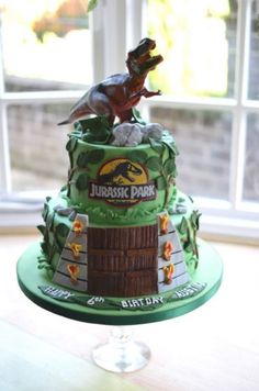 a birthday cake with a dinosaur on top