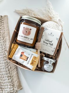 an open gift box containing honey, soap and other items