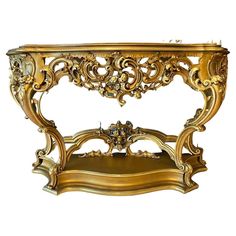 an ornate gold console table with two shelves on each side and one shelf below it